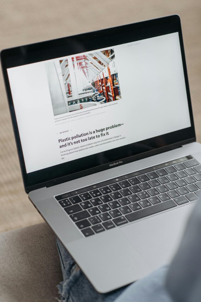 Close-up of a laptop screen showing an article about plastic pollution solutions.